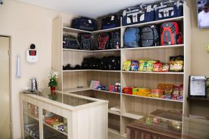 a walk in pantry filled with lots of bags at Hotel Vale das Artes in Embu