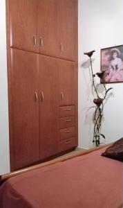 a large wooden cabinet in a bedroom with a bed at Rosmarino in Kissamos