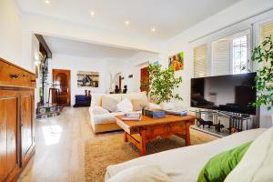 a living room with a couch and a table at VILLA ES TORRENTÓ (HIGH FLYER) in Palma de Mallorca
