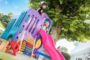 a boy is playing on a play set on a playground at Hotel Bella Igea in Bellaria-Igea Marina