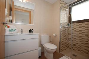 a bathroom with a toilet and a sink and a shower at Apartments Gran VP in Cambrils