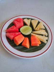 a plate of fruit on a table at Hotel Sorga Cottages in Kuta