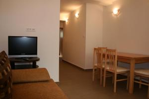 a living room with a dining room table and a television at Apartments Mrduljaš in Split