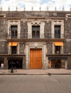 a large brick building with a brown door at Downtown in Mexico City