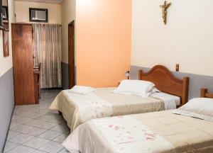 Giường trong phòng chung tại Pousada Cantina Italiana