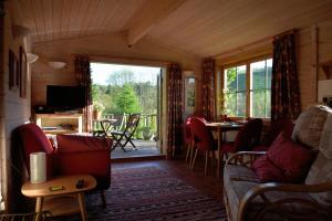a living room with a couch and a table at Log Cabin in Brecon