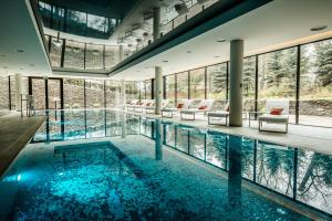 a large swimming pool with chairs and tables in a building at Zamek Topacz in Wrocław