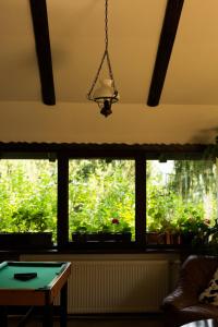 a room with a window with a table and a lamp at Pension Cabana Ionela in Vama