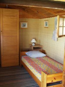 a bedroom with a bed and a lamp in it at Posada Chloe Santiago in Santiago de la Ribera