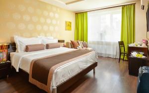 a hotel room with a large bed and a window at Easy Room in Nizhny Novgorod