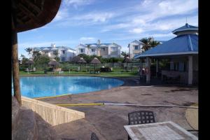 a swimming pool with a hose next to a house at Pinnacle Point Lodge 81 in Mossel Bay