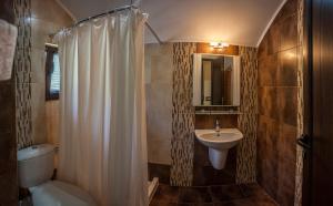 a bathroom with a white shower curtain and a sink at Ваканционна къща ,,Родопски уют " in Dospat +31 photos