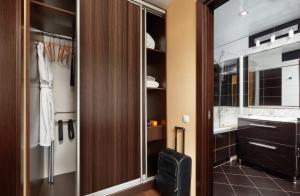 a bathroom with a walk in closet and a sink at Easy Room in Nizhny Novgorod