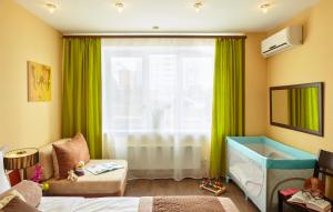 a childs bedroom with a tub and a window at Easy Room in Nizhny Novgorod