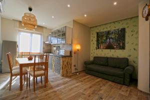 a living room with a table and a green couch at Sea&Skyview in Sorrento