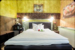 Postel nebo postele na pokoji v ubytování Hotel Don Giovanni