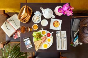a table with eggs and a plate of food at Easy Room in Nizhny Novgorod