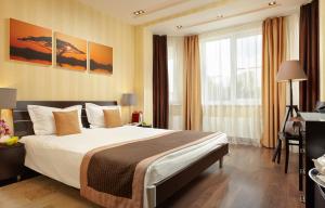 a hotel room with a large bed and a window at Easy Room in Nizhny Novgorod