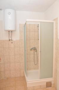 a shower with a glass door in a bathroom at National monument Mehmedbasica Kuca in Stolac