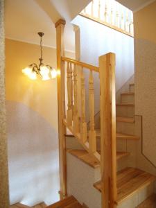 a staircase in a house with a chandelier at Domek Na Wierchu i Apartament na Wierchu in Zakopane