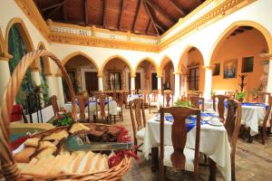 a dining room with tables and chairs in a building at Mansion de los Angeles in San Cristóbal de Las Casas