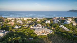 an aerial view of a town with houses and the ocean at Red Box Villa in Plettenberg Bay