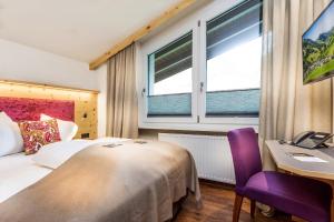 Rúm í herbergi á Hotel Talblick