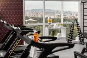 a gym with a view of a city at Intercity Porto Alegre Cidade Baixa in Porto Alegre