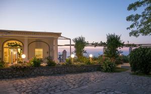 a house with a stone walkway in front of a building at Hotel Bellavista in Anacapri