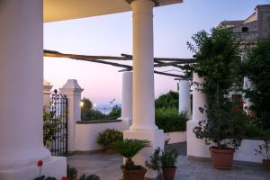 a patio with a pergola and potted plants at Hotel Bellavista in Anacapri