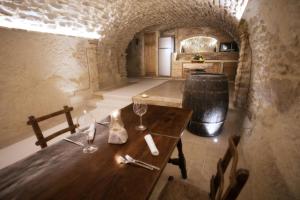 a wooden table with wine glasses and a barrel at Il Casanova in Tropea