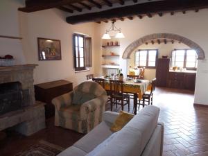 a living room with a table and a dining room at Borgo Beccanella in Asciano