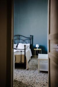 a bedroom with a bed and a blue wall at BellAqua in Catania