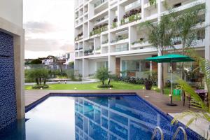 a swimming pool in front of a building at Mesón de la Luna Hotel & Spa in Mérida