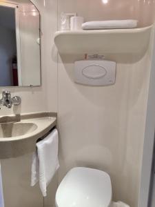 a small bathroom with a toilet and a sink at Première Classe Epernay in Épernay