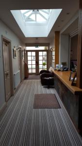 a large room with a skylight and a lobby with a couch at Castle Limes Hotel in Warwick