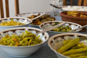 a table topped with bowls of different types of food at First House Mihintale in Mihintale