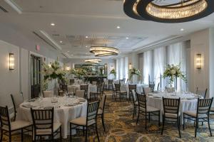 a banquet room with tables and chairs with white tablecloths at The Goodwin in Hartford