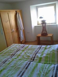 a bedroom with a bed and a window and a lamp at Apartma Pr' Vok in Lesce