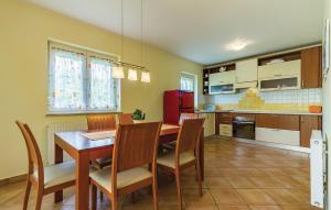 a kitchen with a dining room table and chairs at Holiday House Barbara in Medulin