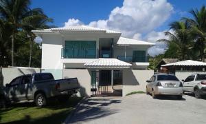 a truck parked in front of a white house at Areia do Atlantico Hotel in Porto Seguro