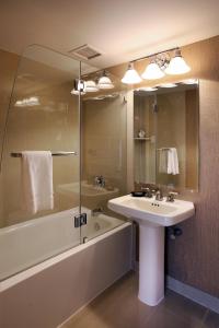 
a bathroom with a tub, sink and mirror at Resorts Casino Hotel Atlantic City in Atlantic City
