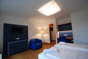 
a hotel room with a bed and a television at Kolping Campus Krems in Krems an der Donau

