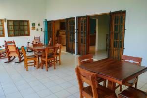 a dining room with wooden tables and chairs at Hotel Fontana in Managua