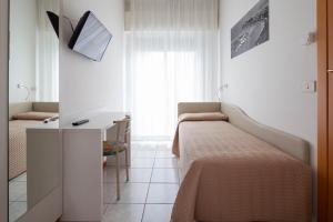 Postel nebo postele na pokoji v ubytování Hotel Columbia & Ninfea