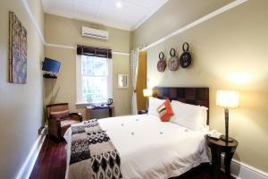 Ένα ή περισσότερα κρεβάτια σε δωμάτιο στο Jardin d'ébène Boutique Guesthouse +50 φωτογραφίες