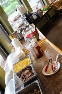 a buffet line with food on a counter at Stone Fence Resort in Ogdensburg