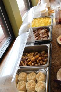 a buffet with trays of different types of food at Stone Fence Resort in Ogdensburg
