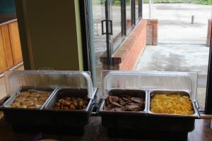 two trays of different types of food on a counter at Stone Fence Resort in Ogdensburg