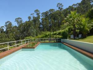 a swimming pool on the roof of a house at Quinta das Leiras in Santo Tirso